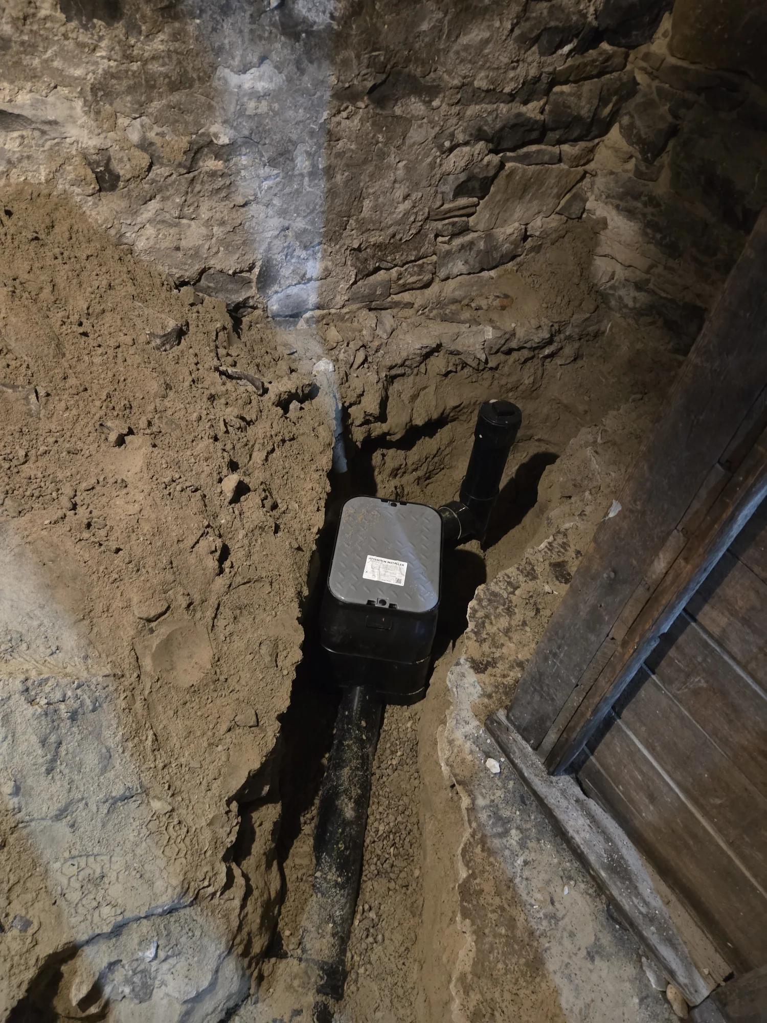 Backwater valve installed in an open basement drain trench