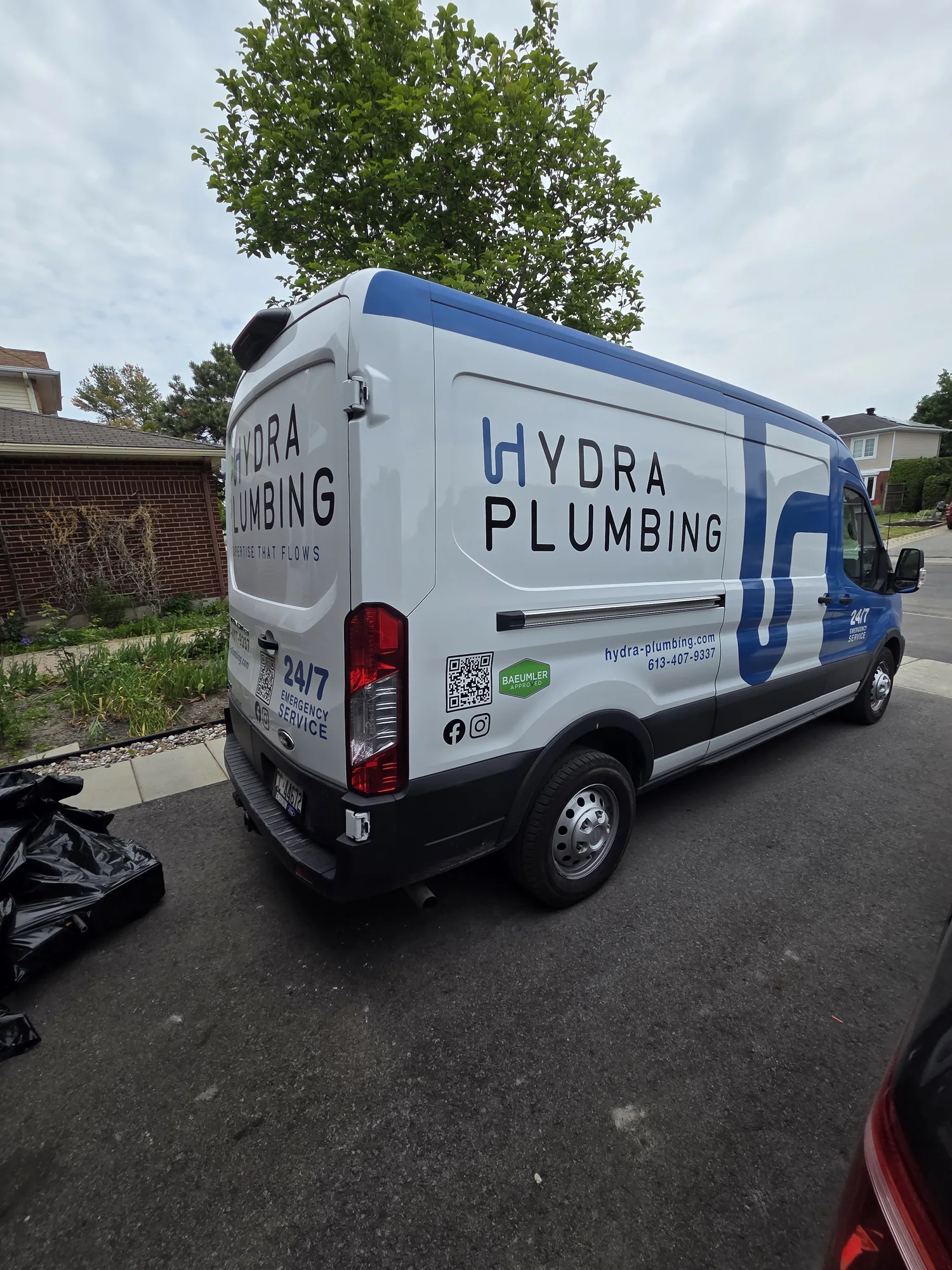 Hydra Plumbing branding on the rear and side of the service van
