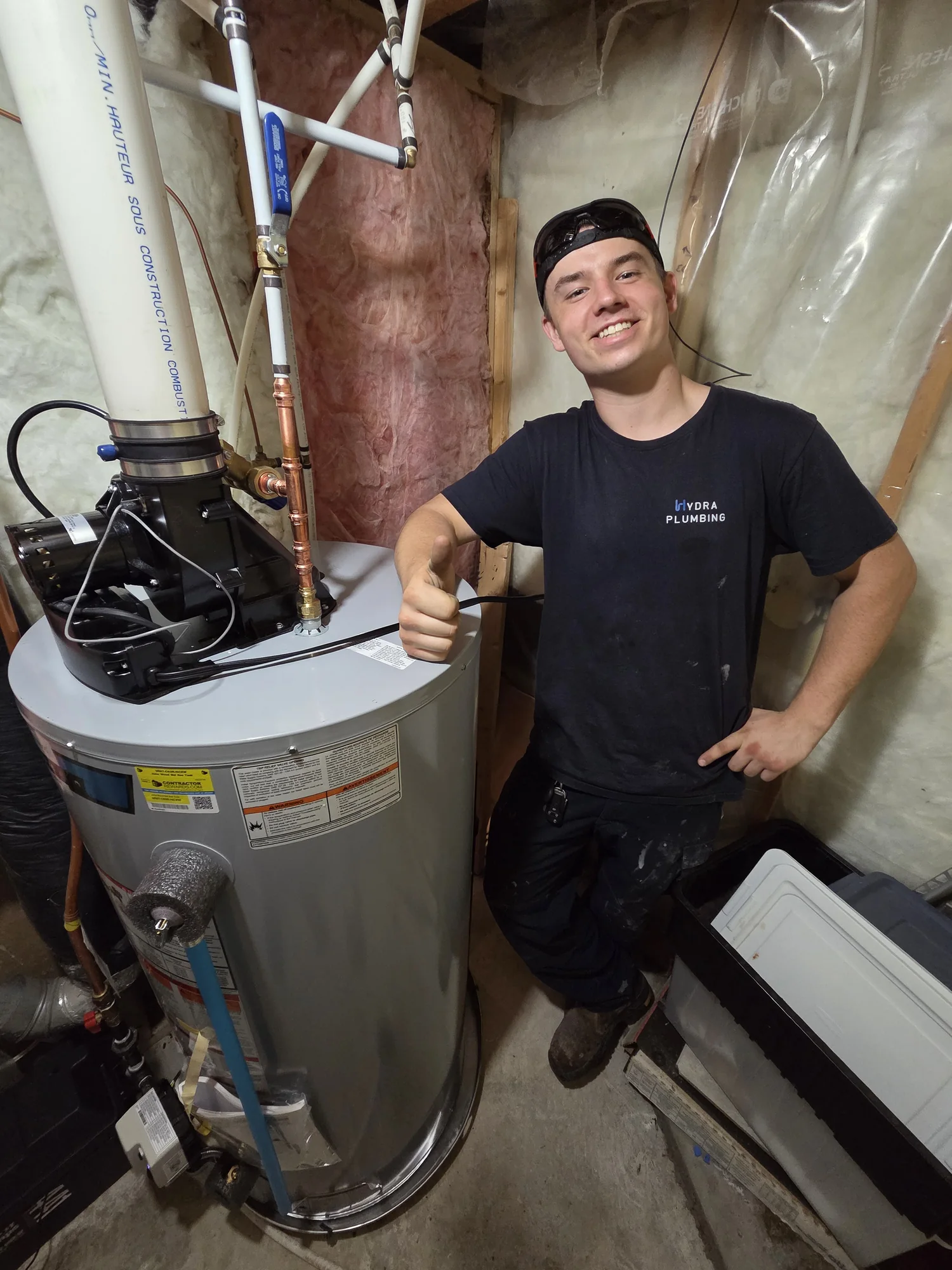 Hydra plumber beside a newly installed water heater