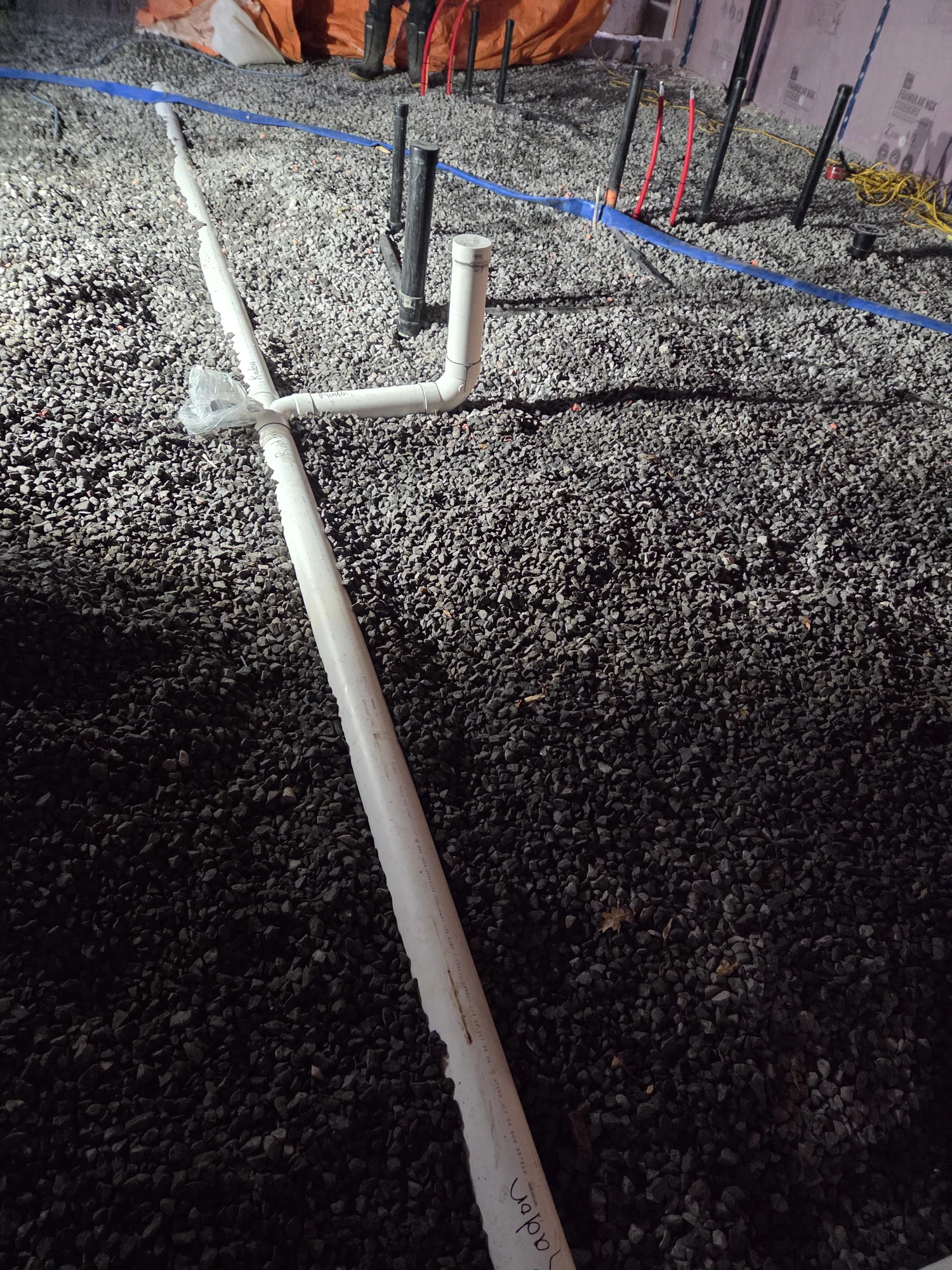 White PVC drain branches laid in gravel
