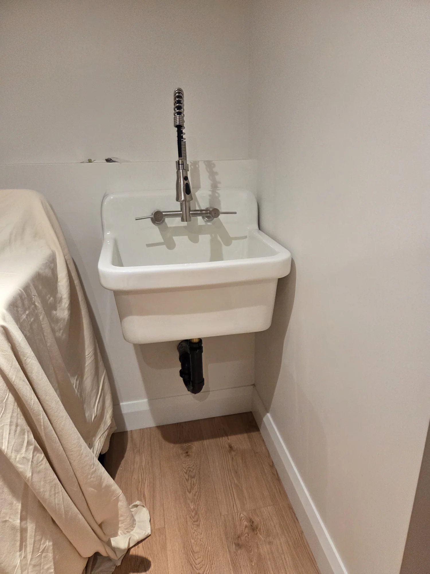 Wall-mounted utility sink with faucet and drain